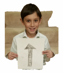 The author's oldest son holds up a sign with an arrow pointing "North" with the word "Carino" embedded in the arrow.