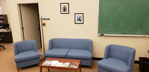 UW Writing Center "Lounge" Area: Two blue chairs, a blue loveseat, and a coffee table.