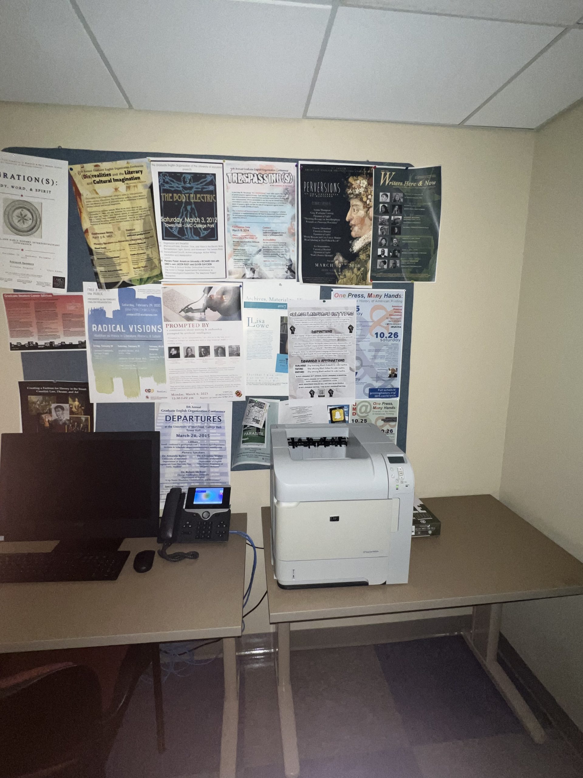Figure 4: #BlackLanguageMatters poster pinned to a bulletin board full of flyers and posters. The bulletin board is behind a printer and a computer.