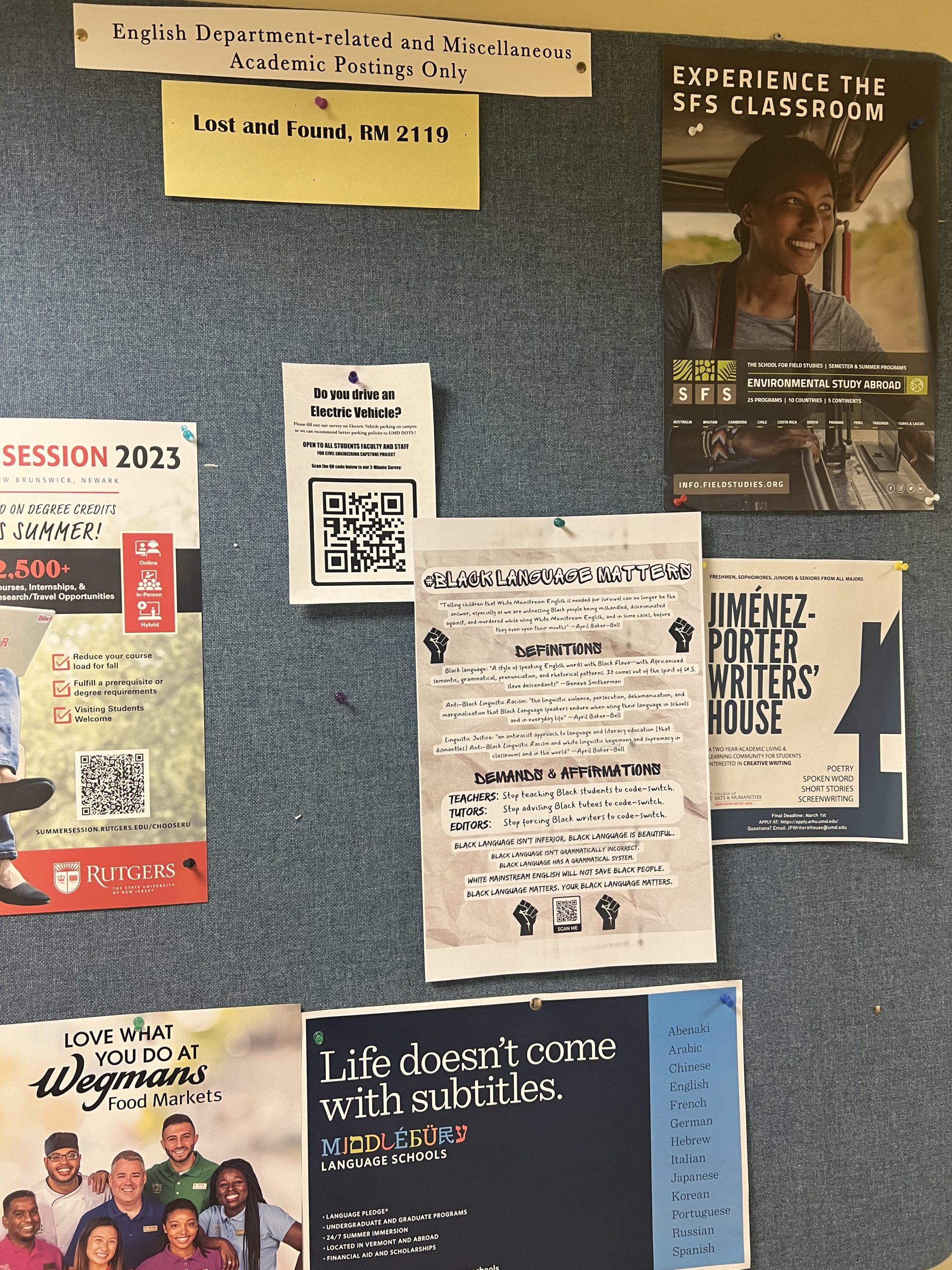 Figure 6: #BlackLanguageMatters poster pinned to a blue bulletin board with other flyers pinned around it.